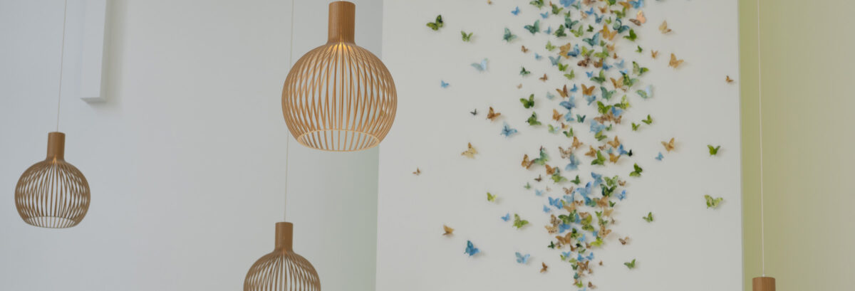 Lobby of the New York Proton Center featuring a wall of colorful butterflies